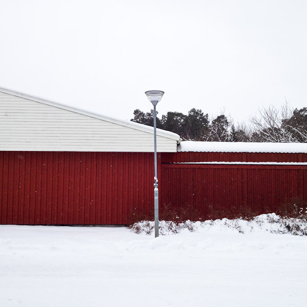 Lamppost in front of red building in Uppsala, Sweden