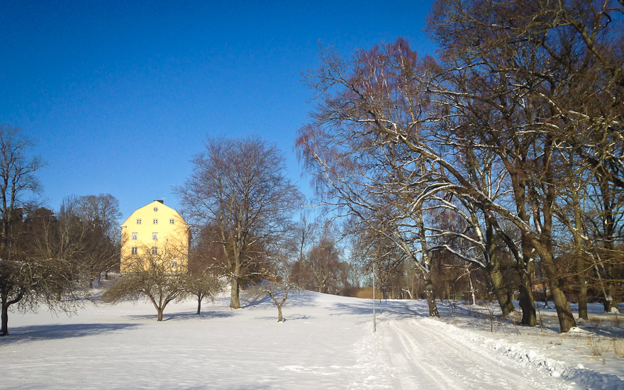 Winter landscape with yellow house in Uppsala, Sweden